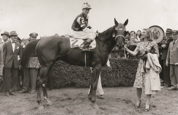 Helen Kleberg steadies 1946 Triple Crown champion Assault after the chestnut colt won the Belmont Stakes with Warren Mehrtens up.