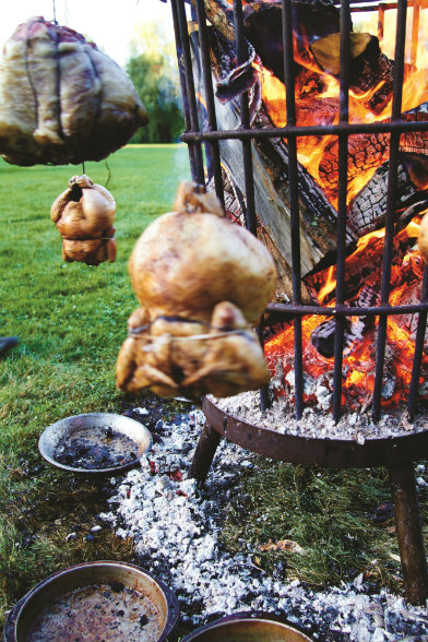 THE HEAT IS ONE. Wood-grilled sumac-rubbed heritage chickens cook to perfection.